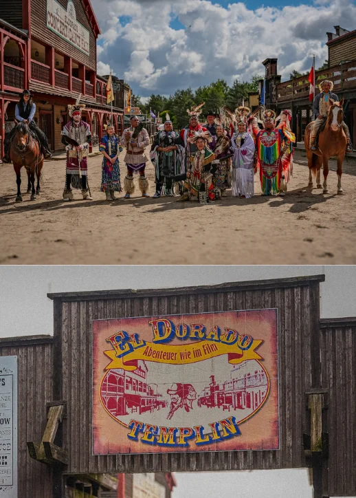 Eine Gruppe von Menschen in traditioneller, farbenfroher Kleidung steht nebeneinander auf einer breiten, sandigen Straße im Eldorado Erlebnispark.